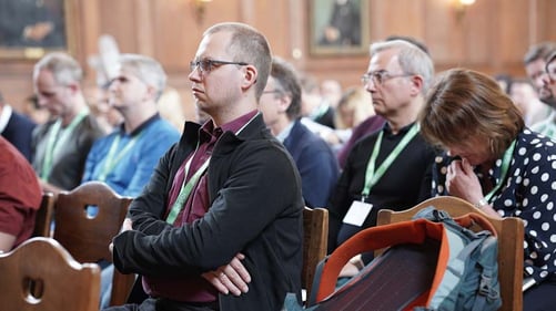 Auidence members listen to a presentation.